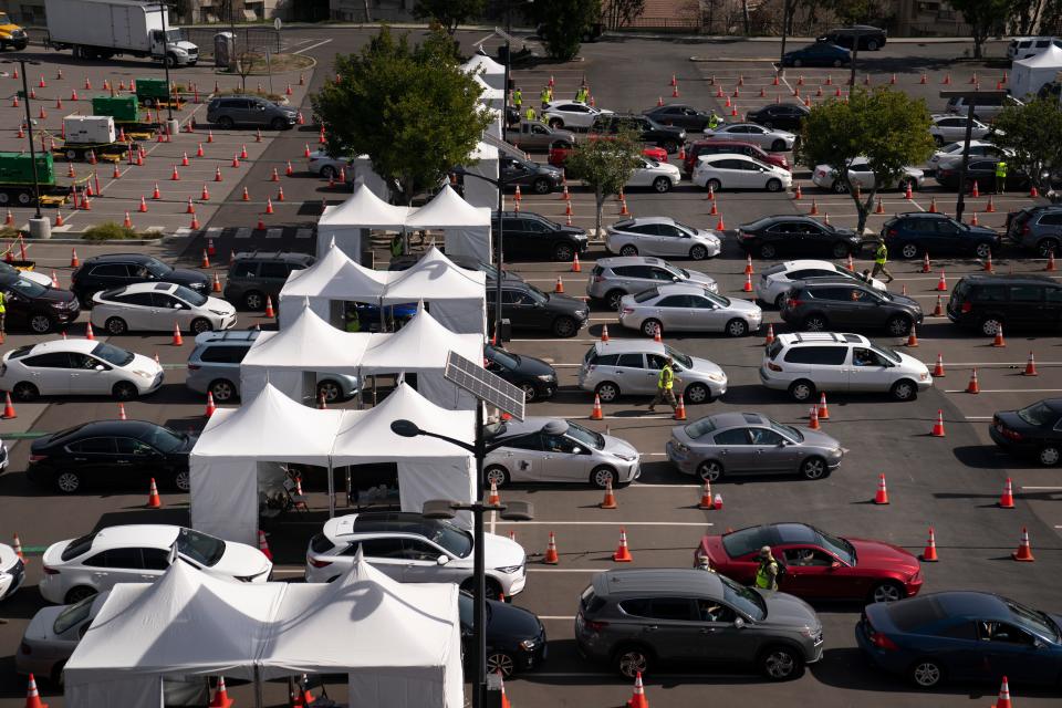 Motorists line up for their COVID-19 vaccine a joint state and federal mass vaccination site set up on the campus of California State University of Los Angeles in Los Angeles,Tuesday, Feb. 16, 2021.