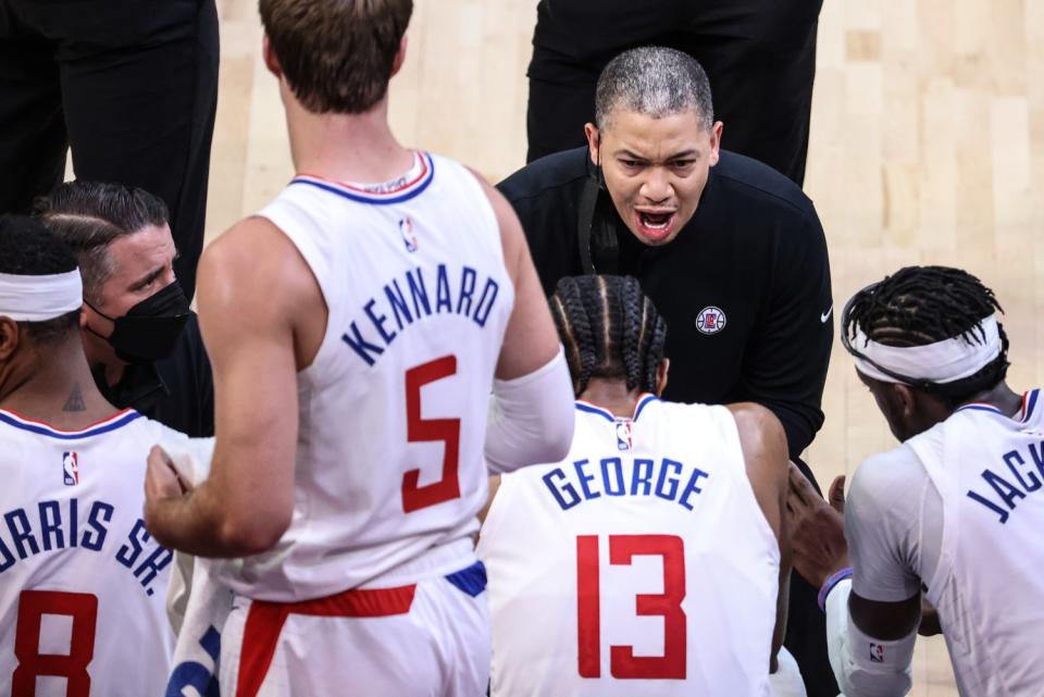 Clippers head coach Tyronn Lue leads an animated huddles during a break in the action against the Phoenix Suns.