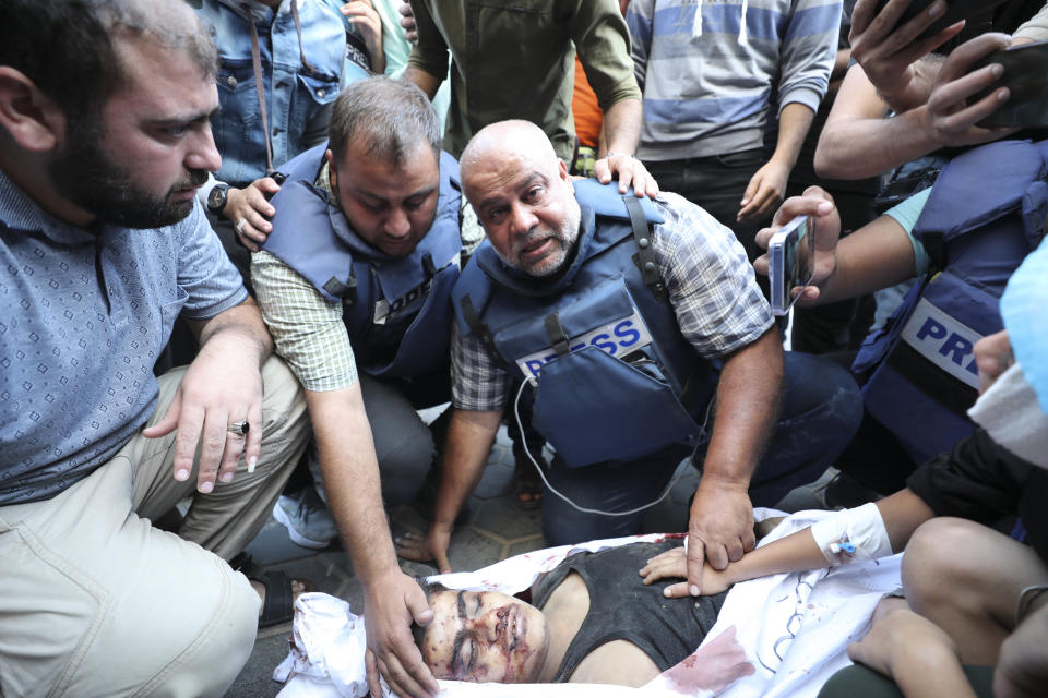 Al Jazeera correspondent Wael Dahdouh mourns his son killed in an Israeli airstrike at Nuisserat refugee camp, outside a hospital in Deir al Balah, south of the Gaza Strip, Thursday, Oct. 26, 2023. Dahdouh's wife, son, daughter, and grandson were killed in the strike. (AP Photo/Ali Mahmoud)