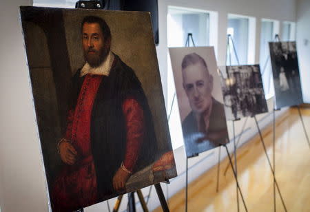 The 17th century painting "Portrait of a Man" which belonged to German Holocaust victim Dr. August Liebmann Mayer, (seen in photo at center) is displayed at a ceremony at the Jewish Heritage Museum in New York officially returning the painting to Mayer's heir, May 5, 2015. REUTERS/Mike Segar