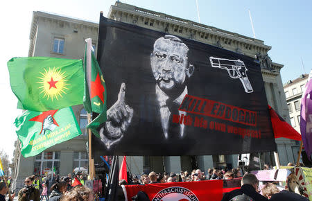 People hold banners and flags during a demonstration against Erdogan dictatorship and in favour of democracy in Turkey in Bern, Switzerland March 25, 2017. REUTERS/Ruben Sprich