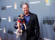 Cast member Jon Lovitz poses with a dog after a panel for "The New Celebrity Apprentice" in Universal City, California, December 9, 2016. REUTERS/Danny Moloshok