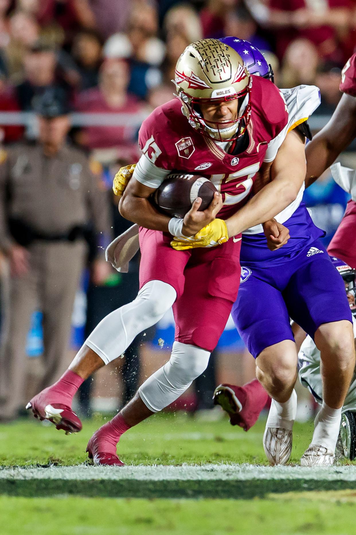Florida State quarterback Jordan Travis (13) is tackled by North Alabama defensive back Shaun Myers during the first half of an NCAA college football game Saturday, Nov. 18, 2023, in Tallahassee, Fla. Travis was injured on the play. (AP Photo/Colin Hackley)