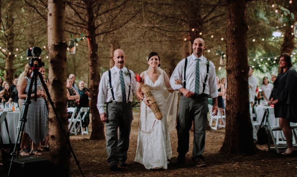 Liz is walked down the aisle by her former father-in-law, Slim Pieniazek, left, and former brother-in-law, Luke Pieniazek. Liz married Jake Cassinari on the grounds of their new home in Springboro September 4, 2018. The former tree farm created a perfect aisle. Family, friends and children, LillyMae, 10, Zoe, 6 and Ever, 4, helped celebrate the happy union. Liz's first husband, Jordan Pieniazek, a Cincinnati firefighter, was killed May 1, 2016. As Jake celebrates his first Father's Day, he and Liz are committed to preserving Jordan's memory for the children.