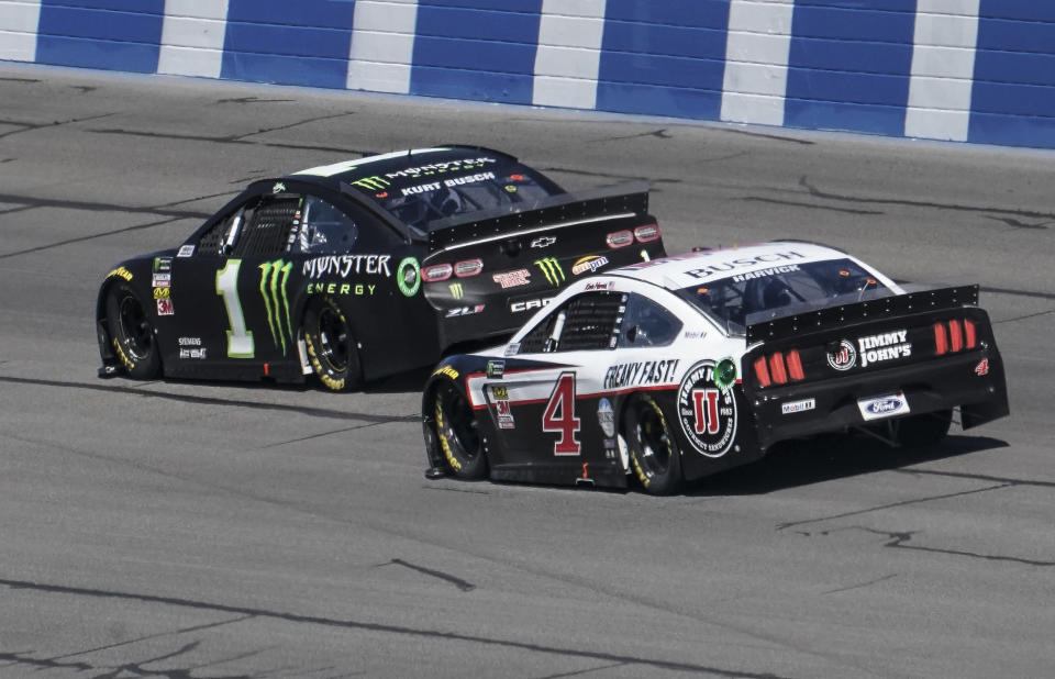 Kurt Busch (1) and Kevin Harvick (4) head into Turn 2 during the NASCAR Cup Series auto race at Auto Club Speedway in Fontana, Calif., Sunday, March 17, 2019. (AP Photo/Rachel Luna)