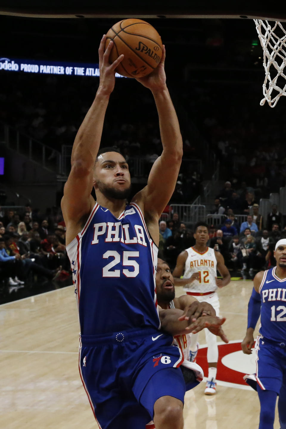 Philadelphia 76ers guard Ben Simmons (25) goes up to shoot as Atlanta Hawks forward Jabari Parker defends in the first half of an NBA basketball game Monday, Oct. 28, 2019, in Atlanta. (AP Photo/John Bazemore)