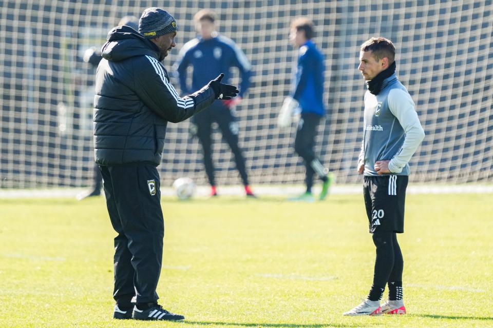 Crew coach Wilfried Nancy talks to midfielder Alexandru Matan during preseason training.