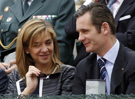 Spain's Infanta Cristina (L) and her husband Inaki Urdangarin speak during the finals of the Barcelona Open tennis tournament in Barcelona in this April 29, 2007 file photo. REUTERS/Albert Gea/Files