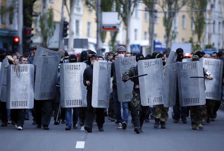 Pro-Russian protesters march with riot police shields during a pro-Ukraine rally in the eastern city of Donetsk April 28, 2014. REUTERS/Marko Djurica