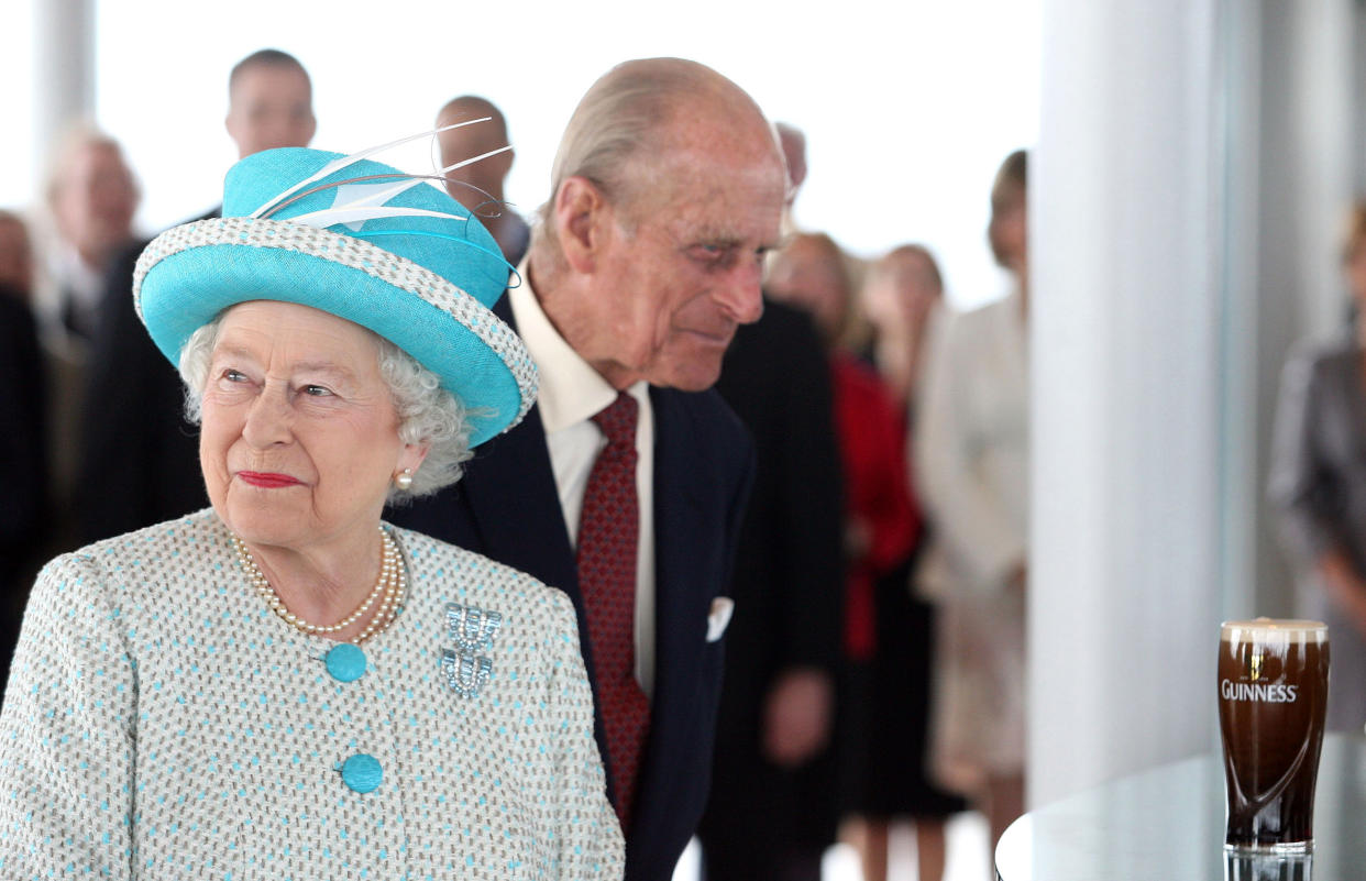 Britain's Queen Elizabeth II (L) and Prince Philip,The Duke of Edinburgh visit the Guinness Storehouse Gravity Bar in Dublin, on the second day of the Queen's four-day visit to Ireland, on May 18, 2011.Queen Elizabeth and her husband Prince Philip resisted the temptation to sup the perfect pint of Guinness on a visit to the Irish cultural icon's home brewery on Wednesday.  AFP PHOTO / Maxwells / POOL (Photo by Maxwells / POOL / AFP) (Photo by MAXWELLS/POOL/AFP via Getty Images)