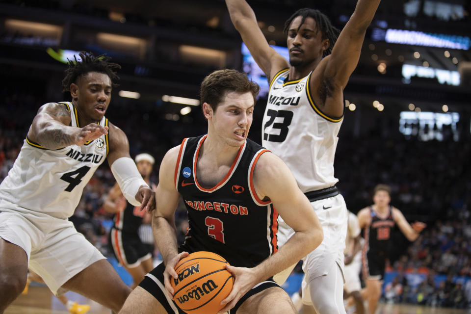 Princeton guard Ryan Langborg (3) is double-teamed by Missouri forward Aidan Shaw (23) and guard DeAndre Gholston (4) during the second half of a second-round college basketball game in the men's NCAA Tournament, Saturday, March 18, 2023, in Sacramento, Calif. Princeton won 78-63. (AP Photo/José Luis Villegas)