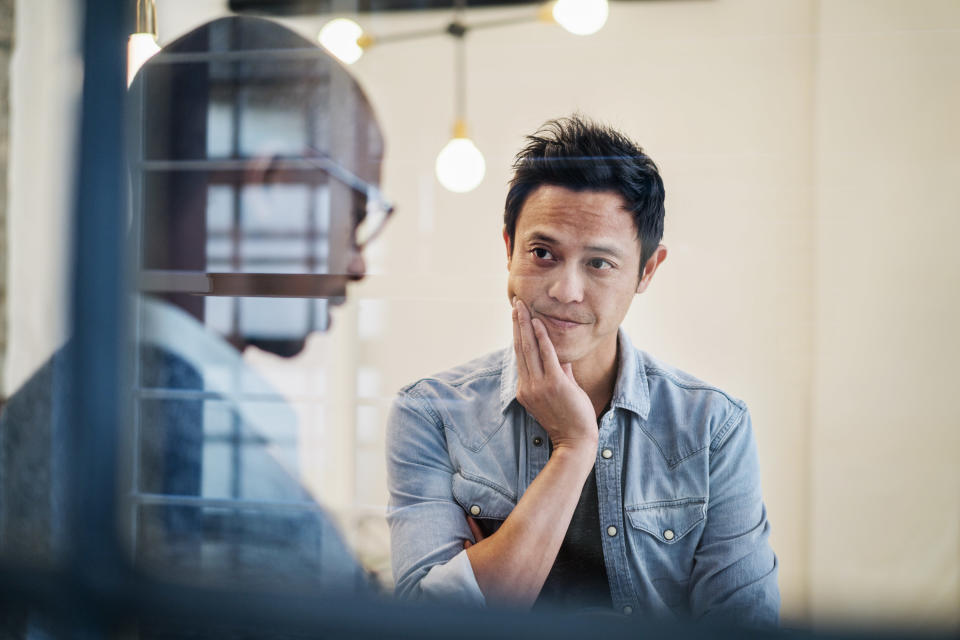 A man listens to a colleague during a serious conversation