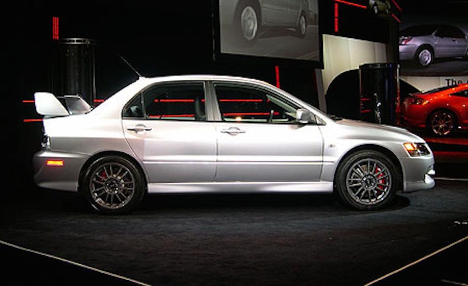 The Evolution IX made its debut at the New York auto show in April 2005. “Exterior changes include new front and rear bumpers, with the former sporting two oval openings that aid the intercooler; an available Gurney flap—a thin wing extension that increases downforce to the rear—for the rear airfoil; and new Enkei aluminum wheels that are lighter by 3.3 pounds each,” <a href="http://www.caranddriver.com/news/mitsubishi-lancer-evolution-ix-auto-shows" rel="nofollow noopener" target="_blank" data-ylk="slk:we reported;elm:context_link;itc:0;sec:content-canvas" class="link ">we reported</a>. “In the cockpit, subtle modifications include aluminum pedals (except in the RS), a faux-carbon-fiber panel on the dash, and Recaro seats covered in pseudo-suede and leather. Under the IX’s aluminum hood resides the familiar 4G63 turbocharged inline four-cylinder engine, which for ’06 has received MIVEC variable valve timing, a larger turbo-impeller housing, new piston oil rings, and a stouter nylon-reinforced timing belt. The result is ten more horsepower—up to 286—and three additional pound-feet of torque, now at 289.” So, in summary, the Evo IX was a slightly updated Evo VIII.