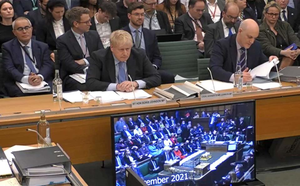 Boris Johnson listens as a clip is shown of him addressing the Commons on Dec 1, 2021, during his appearance before the privileges committee on Wednesday - PRU/AFP