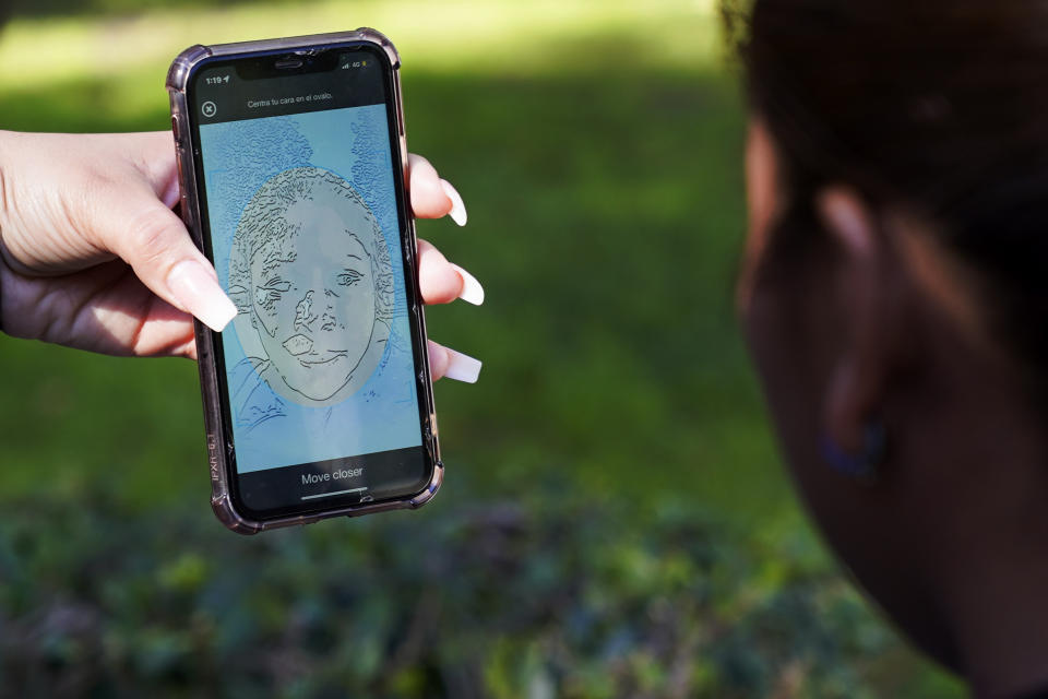 A migrant from Michoacan, Mexico, uses the CBPOne app Tuesday, Jan. 24, 2023, in Tijuana, Mexico. A mobile app for migrants to seek asylum in the United States has been oversaturated since it was introduced this month in one of several major changes to the government's response to unprecedented migration flows. Hoping to get lucky when a new appointments are made available daily, migrants are increasingly frustrated by a variety of error messages. (AP Photo/Gregory Bull)