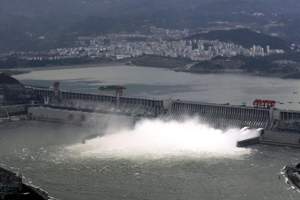 In this Nov. 7, 2008 photo, flow of water is discharged through the Three Gorges Dam in Yichang in central China's Hubei province. State-owned China Three Gorges Group is spending heavily to buy or build hydro, wind and solar projects at a time when Western utility investors are pulling back and U.S. President-elect Donald Trump’s pledge to revive coal use has raised doubt about U.S. support for renewables. (Chinatopix via AP)