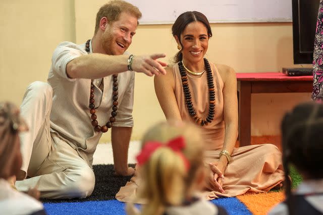 <p>KOLA SULAIMON/AFP via Getty</p> Prince Harry and Meghan Markle visit Lightway Academy in Abuja, Nigeria, on May 10, 2024