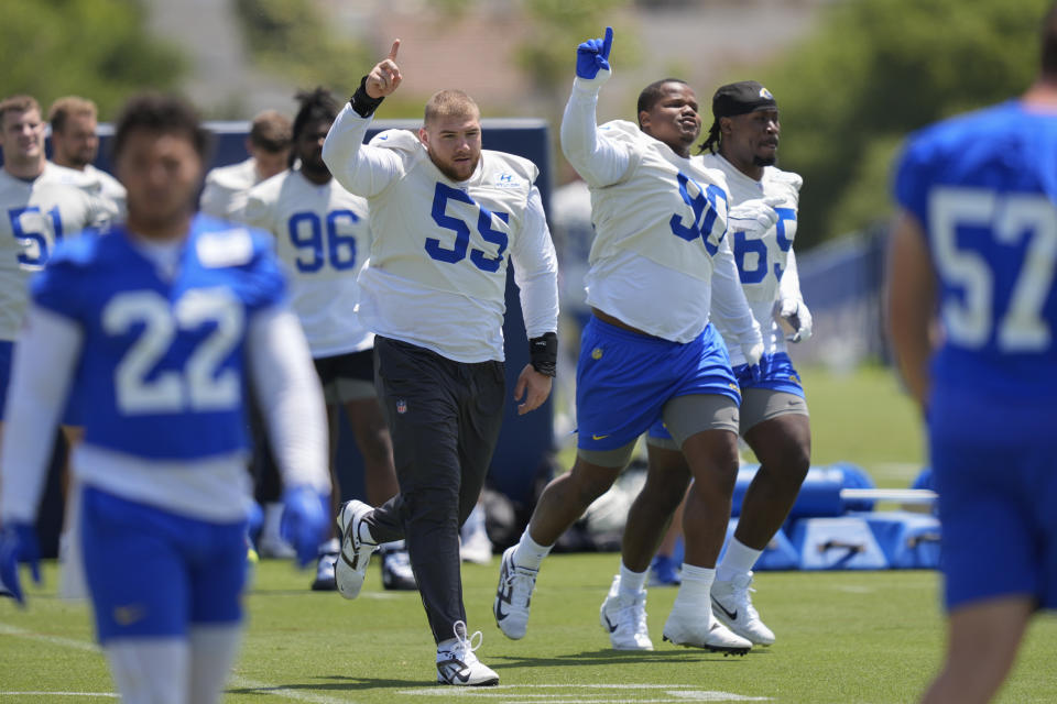 Los Angeles Rams defensive tackle Braden Fiske (55), defensive tackle Tyler Davis (90), and defensive lineman David Olajiga (65) run onto the field during an NFL football organized team activity Tuesday, May 21, 2024, in Thousand Oaks, Calif. (AP Photo/Ryan Sun)