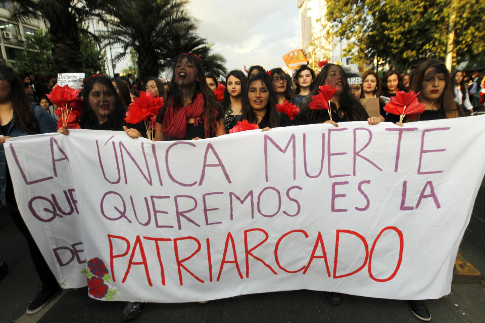 Women take part in a march in Santiago on October 19 with a sign that says, "The one death that we want is that of patriarchy."&nbsp;