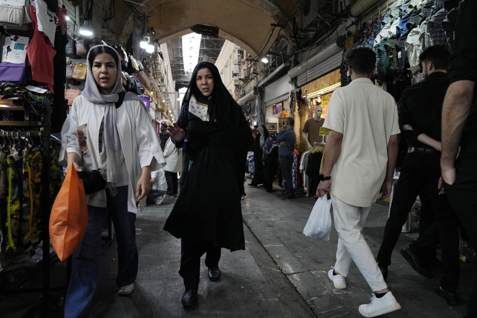 People walk through the old main bazaar of Tehran, Iran, Thursday, June 13, 2024. The rise of the “Hamster Kombat” app in Iran highlights a harsher truth facing the Islamic Republic's economy ahead of its presidential election this week to replace the late President Ebrahim Raisi, who died in a helicopter crash in May. (AP Photo/Vahid Salemi)