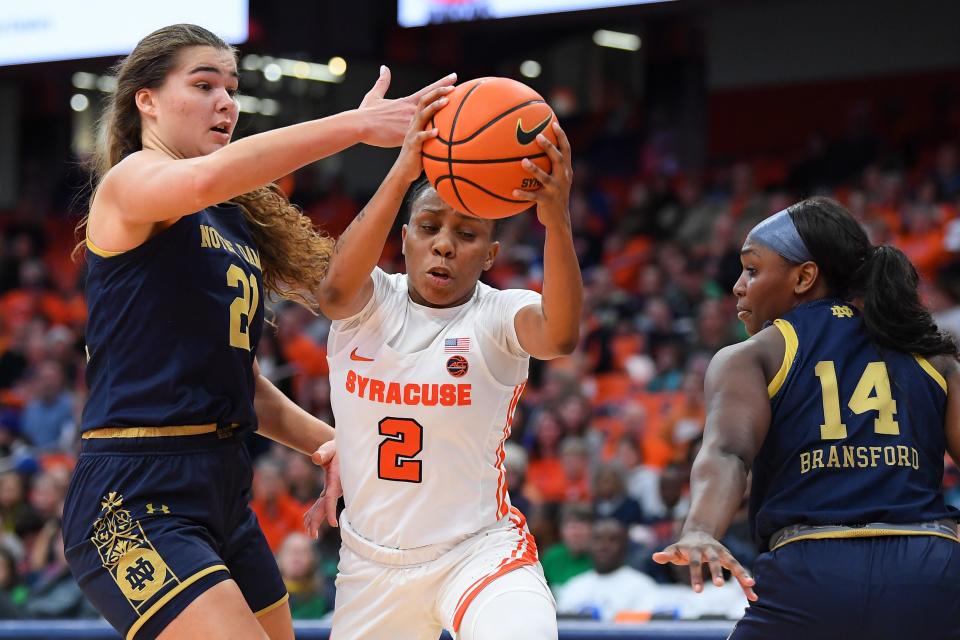 Jan 15, 2023; Syracuse, New York, USA; Syracuse Orange guard Dyaisha Fair (2) drives to the basket between Notre Dame Fighting Irish forward Maddy Westbeld (21) and guard KK Bransford (14) during the first half at the JMA Wireless Dome. Mandatory Credit: Rich Barnes-USA TODAY Sports