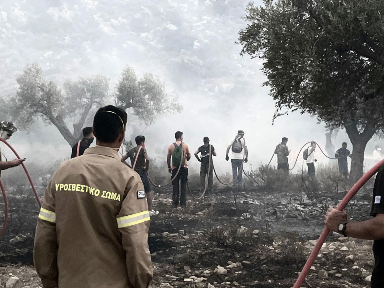 Emergency services trying to put out the wildfires on the island of Rhodes, Greece (PA)