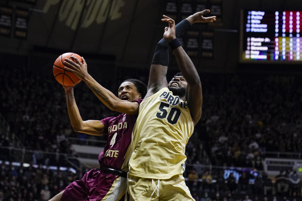 Florida State guard Caleb Mills (4) shoots over Purdue forward Trevion Williams (50) Florida State guard Caleb Mills (4) shoots over Purdue forward Trevion Williams (50) during the first half of an NCAA college basketball game in West Lafayette, Ind., Tuesday, Nov. 30, 2021. (AP Photo/Michael Conroy)