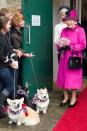 <p>In a bright pink coat with black accents, matching hat, and black shoes for a visit to Sherborne, England, Queen Elizabeth II looked extremely pleased to see the adorable corgis. </p>