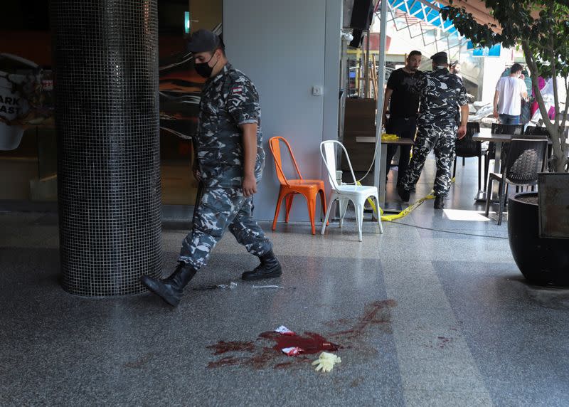 A Lebanese internal security member walks past bloodstains at the site where a man committed suicide in Beirut