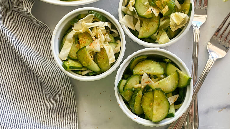 bowls of cucumber cabbage salad