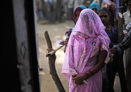 A woman waits in a queue to cast her vote at a polling station in Shabazpur Dor village in Amroha district in the northern Indian state of Uttar Pradesh April 17, 2014. REUTERS/Adnan Abidi