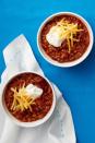 <p>Chili is a classic for a reason. Your guests will love that there's something hardy to eat (especially if there are cocktails flowing!). Just use festive bowls, and you're set.</p><p><strong><a href="https://www.womansday.com/food-recipes/food-drinks/recipes/a53326/beef-and-lentil-chili/" rel="nofollow noopener" target="_blank" data-ylk="slk:Get the Beef and Lentil Chili recipe.;elm:context_link;itc:0;sec:content-canvas" class="link ">Get the Beef and Lentil Chili recipe. </a></strong></p>