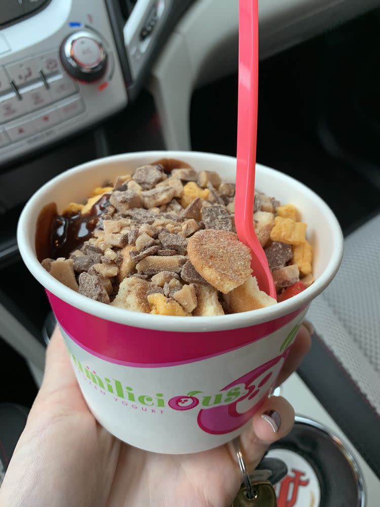 Cup of frozen yogurt with toppings from Yumilicious