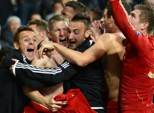 Bayern Munich's midfielder Bastian Schweinsteiger (2nd L) celebrates after scoring the winning penalty during the penalty shoot out at the end of the UEFA Champions League second leg semi-final football match Real Madrid against Bayern Munich at the Santiago Bernabeu stadium in Madrid. Bayern reached the final