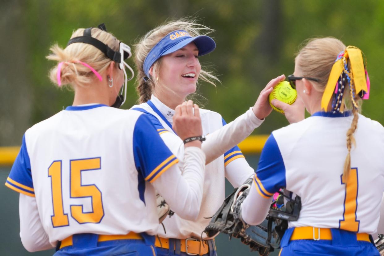Castle Knights Emma Bruggenschmidt (12), middle, high fives her teammates after making an out against the Noblesville Millers during the Carmel Softball Invitational on Saturday, April 20, 2024, at the Cherry Tree Softball Complex in Carmel, Indiana.