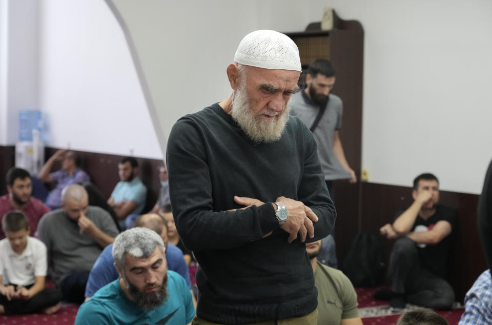 Crimean Tatars pray ina mosque in Kyiv, Ukraine, Friday, Aug. 13, 2021. The fate of Crimean Tatars is one of the top issues at the inaugural meeting of the Crimean Platform on Monday Aug. 23, 2021, an international summit called by Ukraine to build up pressure on Russia over the annexation that has been denounced as illegal by most of the world. (AP Photo/Efrem Lukatsky)