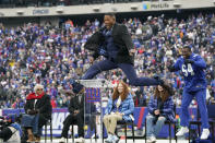 Former New York Giants player Michael Strahan jumps in the air during a halftime ceremony at an NFL football game between the New York Giants and the Philadelphia Eagles, Sunday, Nov. 28, 2021, in East Rutherford, N.J. (AP Photo/Corey Sipkin)