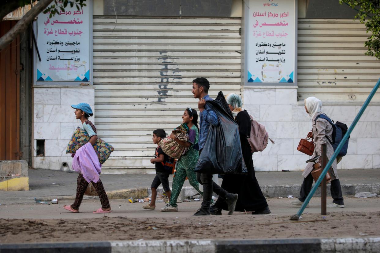 Internally displaced Palestinians, including women and children, flee during an Israeli military operation in Deir Al Balah, central Gaza Strip, 25 August 2024 (EPA)