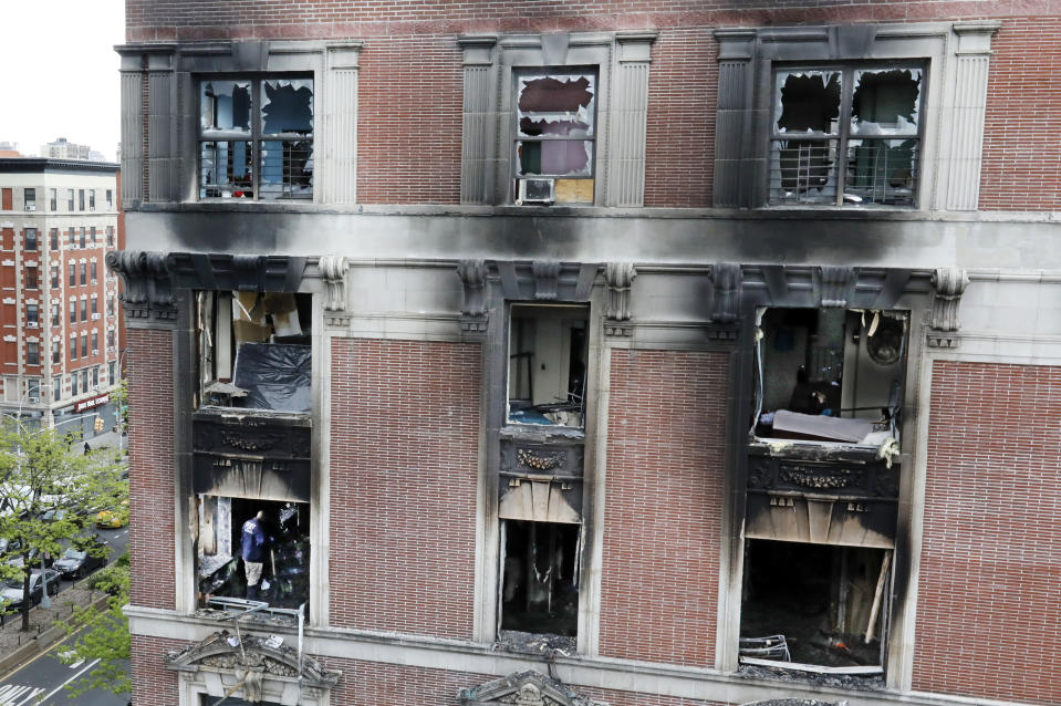 <p>Fire marshals sift through a burned out apartment, lower left window, in New York’s Harlem neighborhood, Wednesday, May 8, 2019. Six people, including four children, were killed Wednesday when an overnight fire ravaged an apartment in a city-owned Harlem building. (AP Photo/Richard Drew) </p>