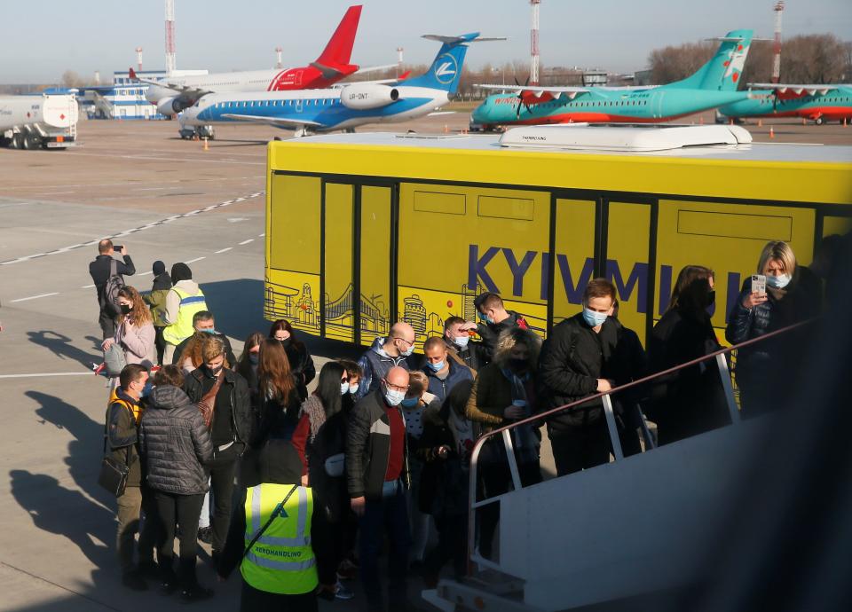 Passengers board a plane during a tour to the Chernobyl exclusion zone at the Boryspil International Airport outside Kyiv, Ukraine April 3, 2021. Ukraine International Airlines made a special offer marking the 35th anniversary of the Chernobyl nuclear disaster. Tourists get a bird's eye view of abandoned buildings in the ghost town of Pripyat and the massive domed structure covering a reactor of the Chernobyl Nuclear Power Plant that exploded on April 26, 1986. Picture taken April 3, 2021.