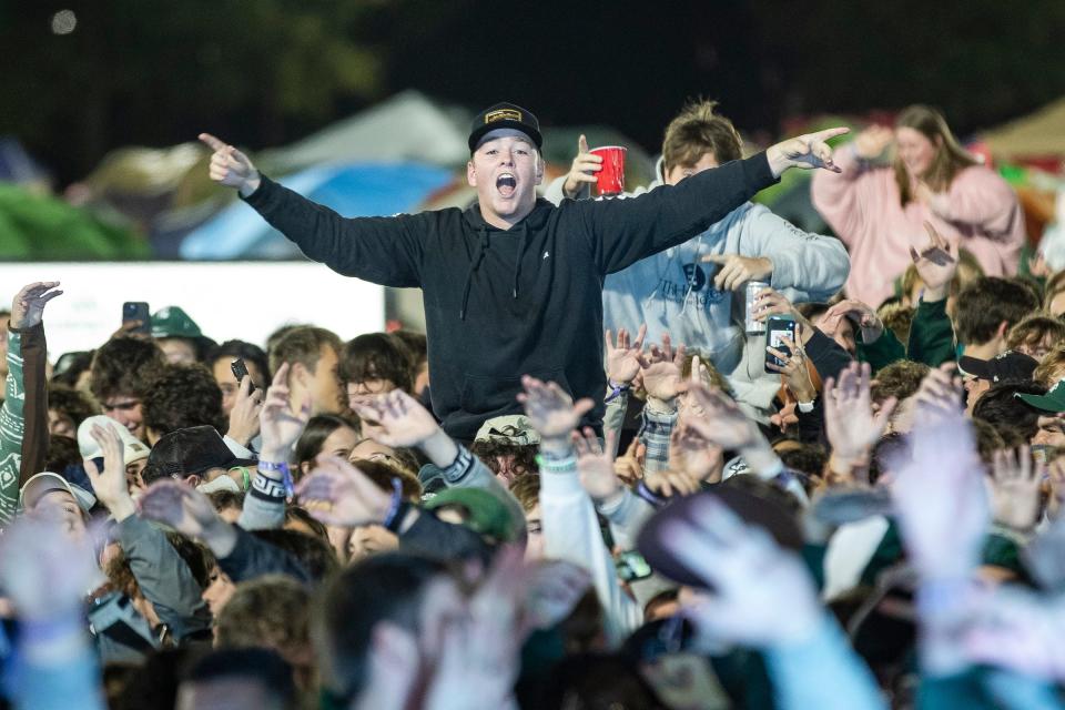 MSU basketball fans cheer during players introduction during Izzone Campout at Munn Field near Breslin Center in East Lansing on Friday, Oct. 6, 2023.