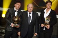 ZURICH, SWITZERLAND - JANUARY 07: Lionel Messi of Argentina receives the FIFA Ballon d'Or 2012 trophy and Abby Wambach of United States receives her FIFA womens player of the year trophy by Joseph Blatter, FIFA president (C) during the FIFA Ballon d'Or Gala 2013 at Congress House on January 07, 2013 in Zurich, Switzerland. (Photo by Christof Koepsel/Getty Images)