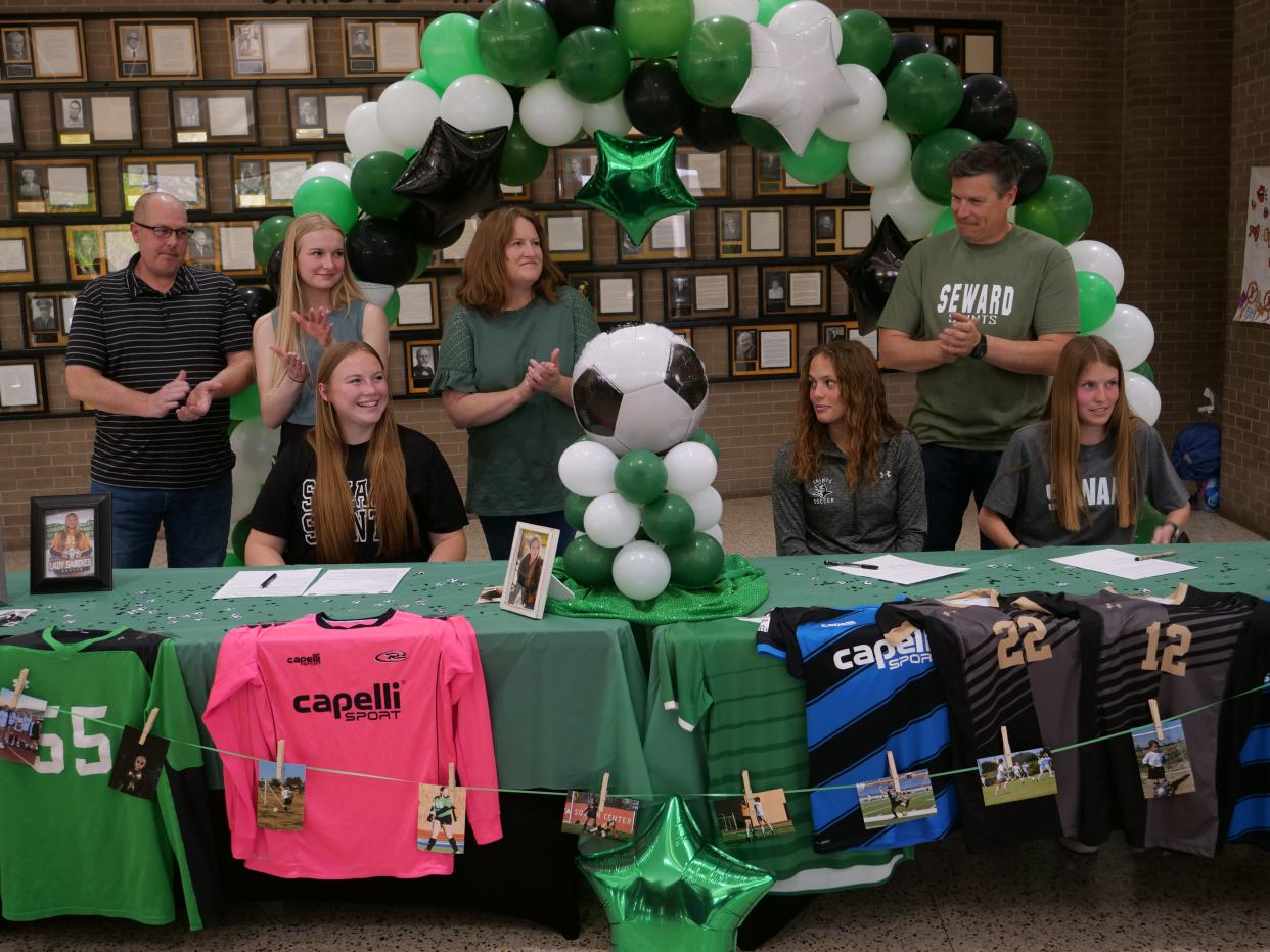 Amarillo High's Sydney Williams (bottom left), Abi Artley (bottom center) and Belle Artley (right) signed their letters of intent to play college soccer for Seward County Community College on Monday, April 17, 2023 at Amarillo High School.