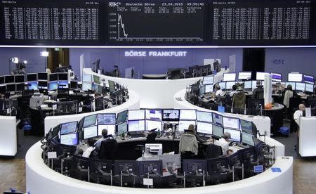 Traders work at their screens in front of the German share price index DAX board at the stock exchange in Frankfurt April 23, 2015. REUTERS/Stringer