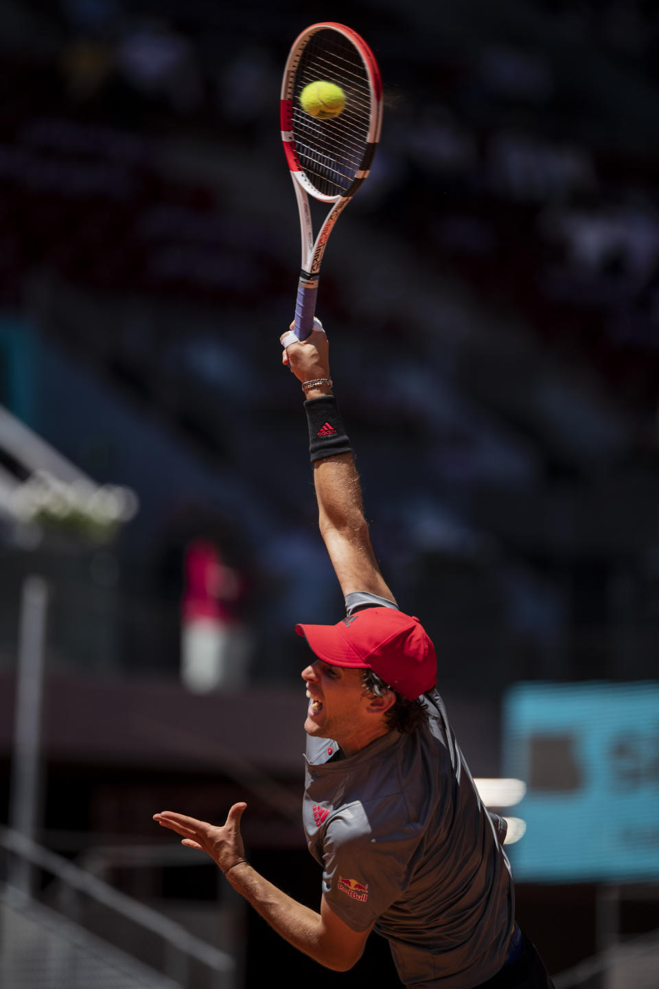 Austria's Dominic Thiem serves to United States' John Isner during their match at the Mutua Madrid Open tennis tournament in Madrid, Spain, Friday, May 7, 2021. (AP Photo/Bernat Armangue)