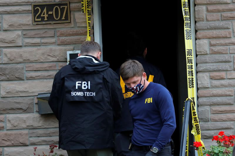 FBI officers outside house where police say bomb-making materials were found, in New York