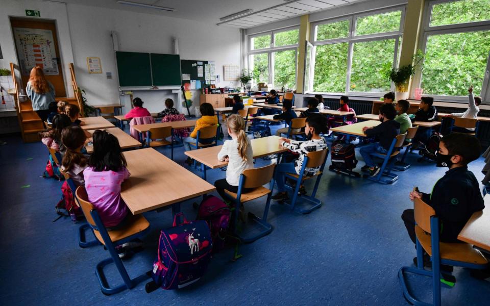 Students sit in a classroom of the Petri primary school in Dortmund, western Germany, on June 15, 2020 amid the novel coronavirus COVID-19 pandemic. - From June 15, 2020, all children of primary school age in the western federal state of North Rhine-Westphalia will once again be attending regular daily classes until the summer holidays. The distance rules and compulsory mouthguards are no longer applicable. (Photo by Ina FASSBENDER / AFP) (Photo by INA FASSBENDER/AFP via Getty Images) - INA FASSBENDER/AFP