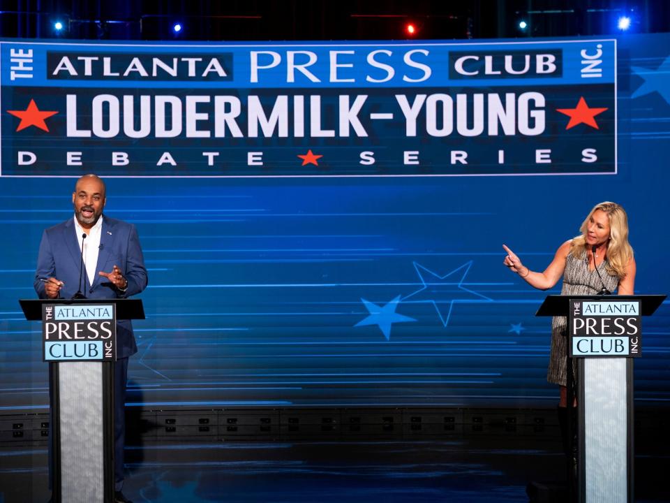 Flowers and Greene during a debate in Atlanta, GA on October 16, 2022.
