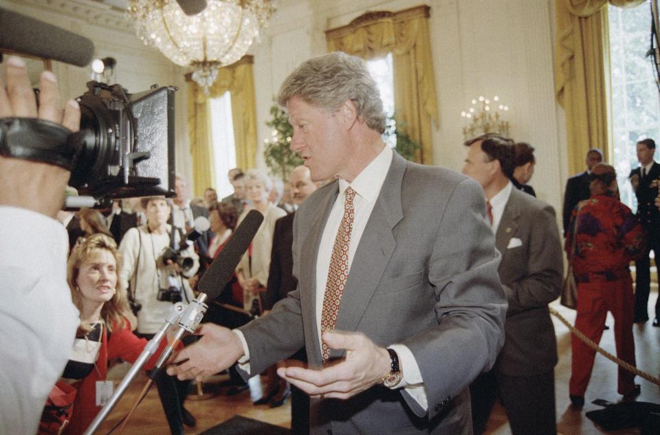 President Bill Clinton stops and talks to reporters as he leaves a White House ceremony in Washington, Monday, April 26, 1993.
