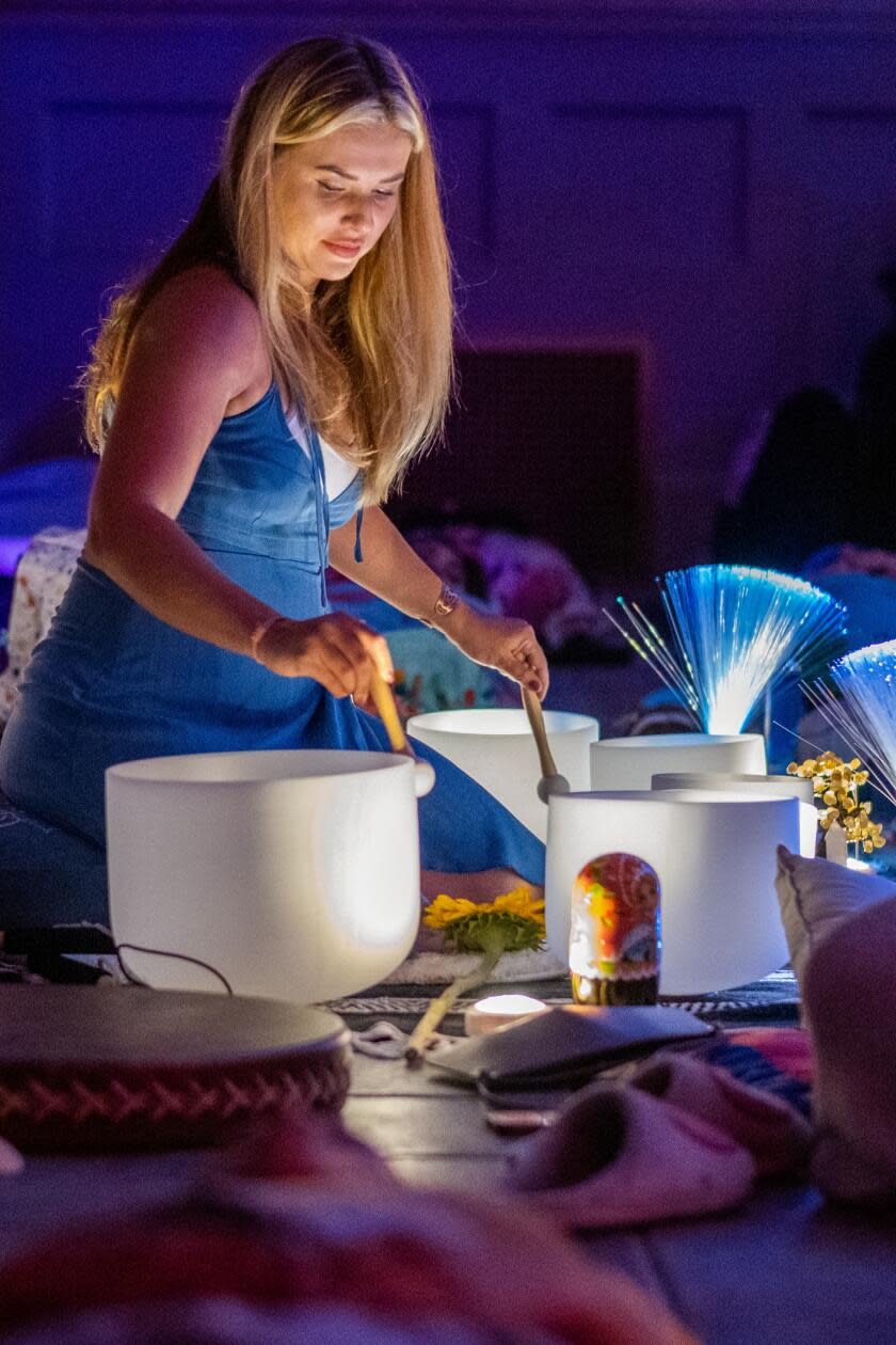 Yana Horowitz, 36, of Calabasas, plays the crystal singing bowls during a sound bath.